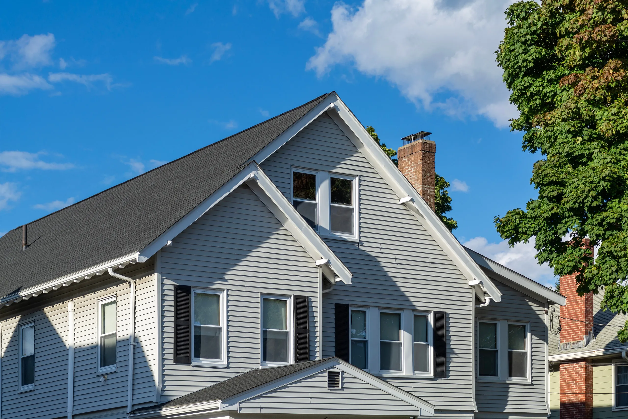 Horizontal lap siding across the gabled upper story of a house